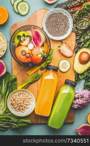 Two smoothie bottles with mix blender and healthy ingredients on kitchen table, top view.  Vegan superfood: Fruits, berries and vegetables, chia seeds, almond, pine nuts. Detox nutrition