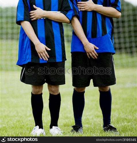 Two soccer players making a wall