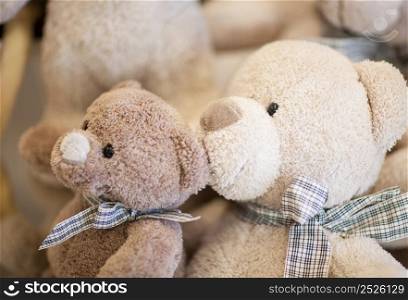 two soft white teddy bear with a tie around his neck closeup. soft Christmas toys and decorations