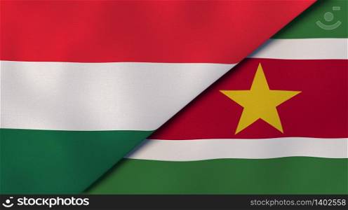 Two states flags of Hungary and Suriname. High quality business background. 3d illustration. The flags of Hungary and Suriname. News, reportage, business background. 3d illustration