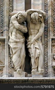 two statues in the front of the dome of milan