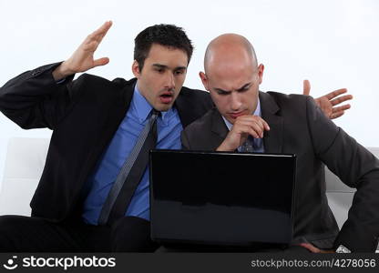 Two stressed office worker with laptop