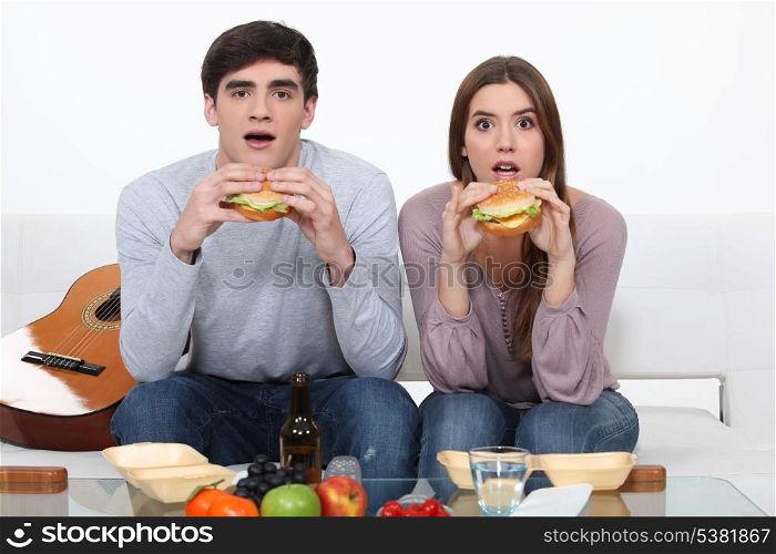 Two students eating burgers