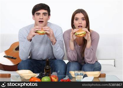 Two students eating burgers