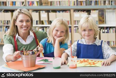 Two students in art class with teacher