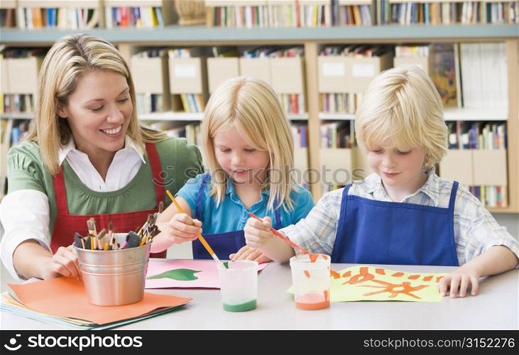 Two students in art class with teacher