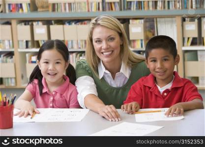 Two students in class with teacher
