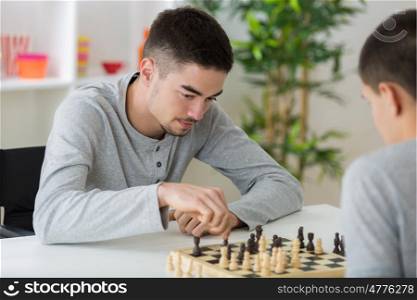 two students playing chess