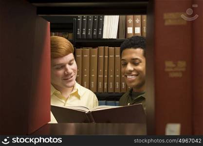 Two students reading in the library
