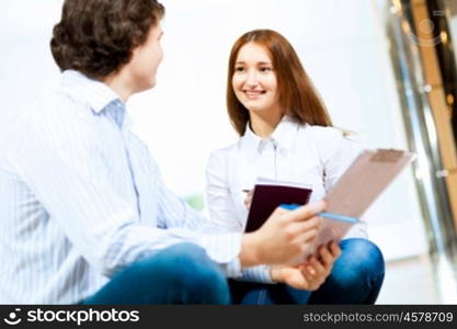 Two students smiling. Image of two students discussing their work