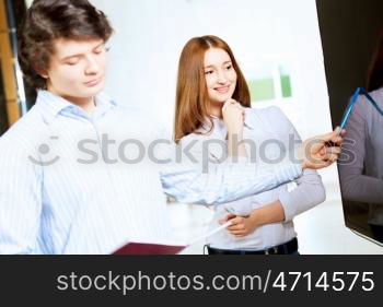 Two students smiling. Image of two students discussing their work