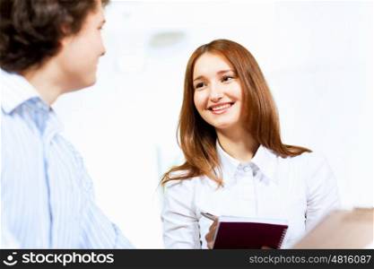Two students smiling. Image of two students discussing their work