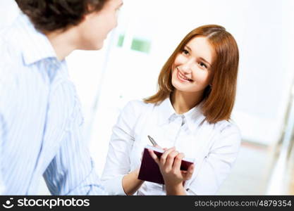 Two students smiling. Image of two students discussing their work