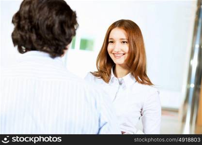 Two students smiling. Image of two students discussing their work