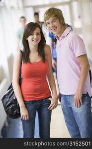 Two students standing in corridor (selective focus)