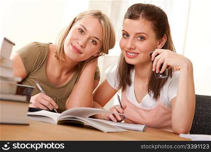 Two students studying home and having coffee