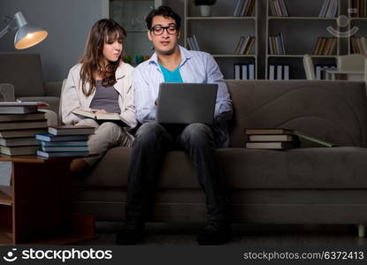 Two students studying late preparing for exams