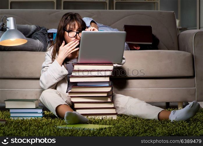 Two students studying late preparing for exams