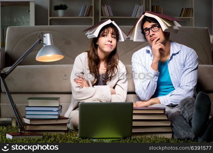 Two students studying late preparing for exams