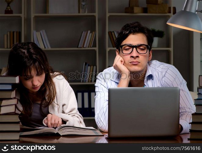 Two students studying late preparing for exams. The two students studying late preparing for exams