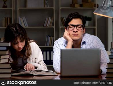 Two students studying late preparing for exams. The two students studying late preparing for exams