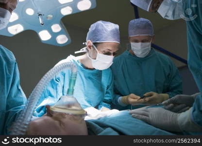 Two Surgeons Operating On A Patient