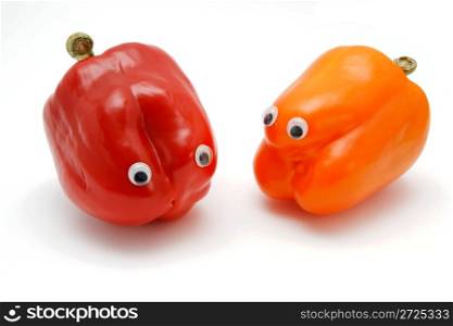 Two sweet bell peppers with eyes isolated