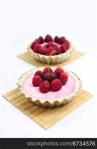 Two tarts with cherries and raspberries
