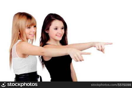 Two teen sisters pointing isolated on white background