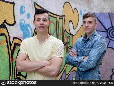 Two teenage boys in the street with graffiti background