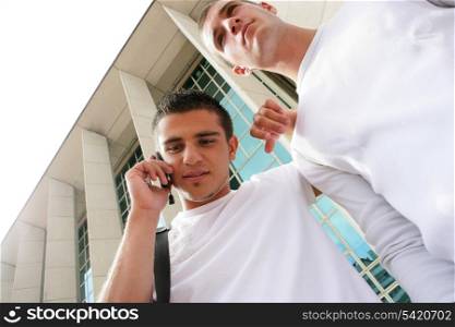 two teenage boys near a building