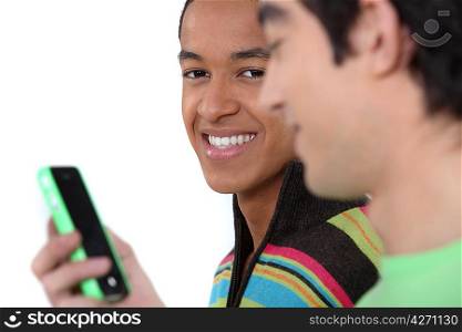 Two teenage boys reading text message