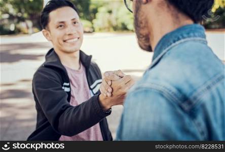 Two teenage friends shaking hands at each other outdoors. Two people shaking hands on the street. Concept of two friends greeting each other with handshake on the street