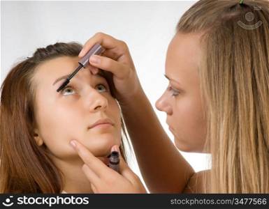 Two teenage girls dye their eyelashes