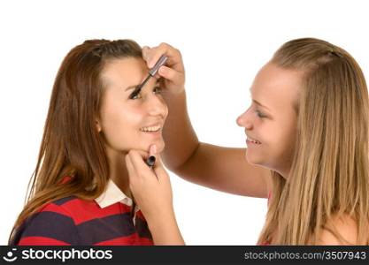 Two teenage girls dye their eyelashes isolated on white