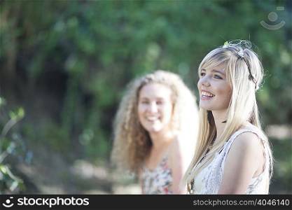Two teenage girls enjoying woodland