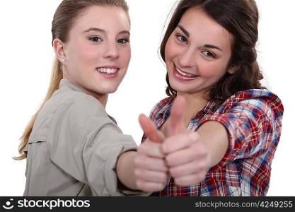 Two teenage girls giving the thumbs-up