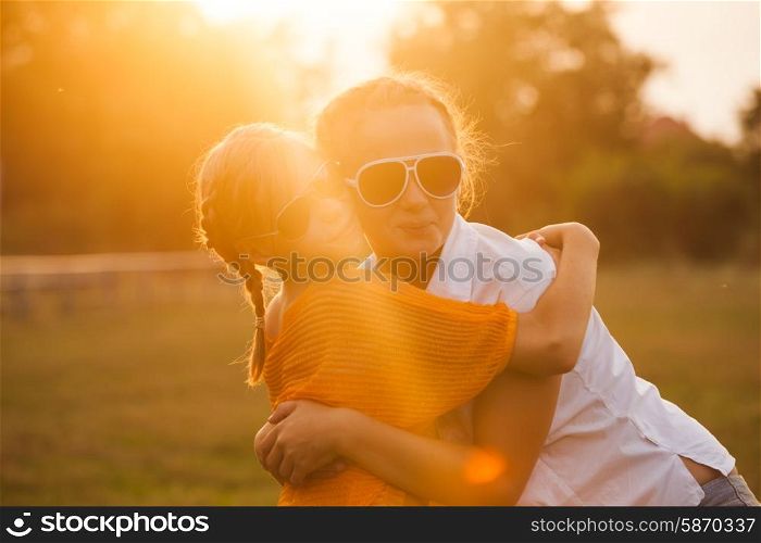 Two teenage girls have fun in the park. Two friends outdoor. Summer people in glasses. Two teenage girls