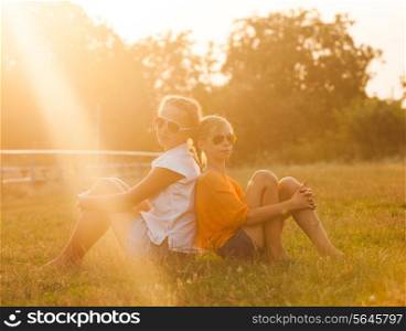 Two teenage girls have fun in the park. Two friends outdoor. Summwer people in glasses