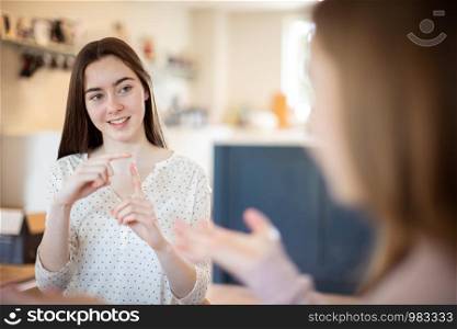 Two Teenage Girls Having Conversation Using Sign Language