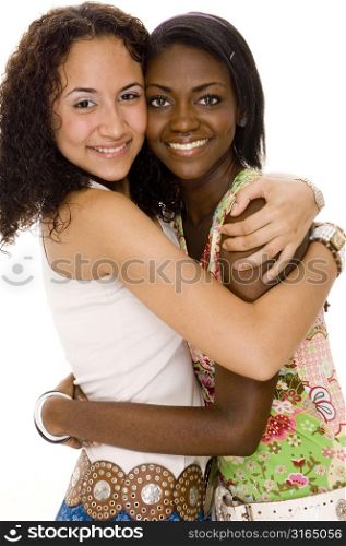Two teenage girls hugging each other and smiling