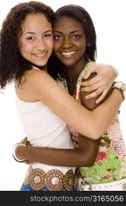 Two teenage girls hugging each other and smiling