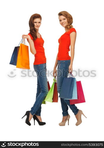 two teenage girls in red t-shirts with shopping bags