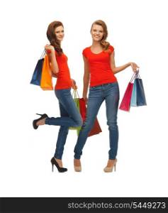 two teenage girls in red t-shirts with shopping bags