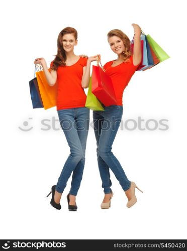 two teenage girls in red t-shirts with shopping bags