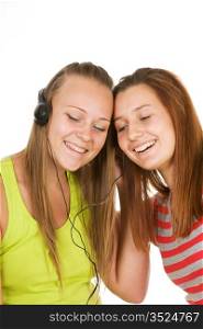 Two teenage girls listening to music isolated on white