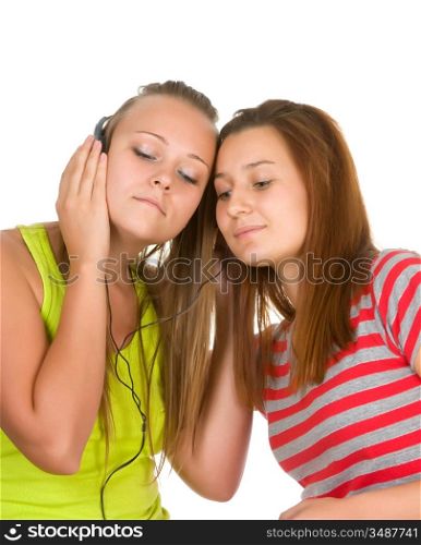 Two teenage girls listening to music on your mobile phone isolated on white