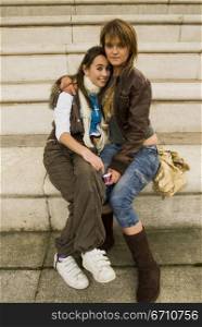 Two teenage girls on steps together
