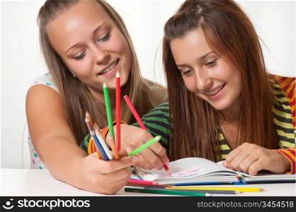 Two teenage girls smiling and painted in the book