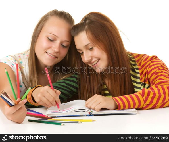 Two teenage girls smiling and reading book isolated on white